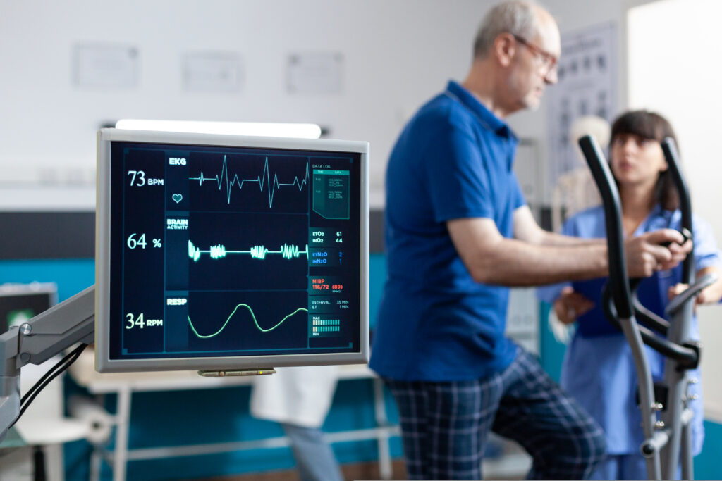 Heart rate monitor showing a different reading of a patient during a cardiac rehab session.